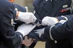 USAF personnel follow the traditional steps of folding the American flag during a ceremony at Ramstein Air Base, Germany