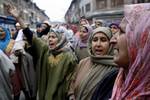 Relatives of ruling National Conference worker Bashir Ahmed Dar grieve during the funeral procession in Srinagar on December 24, 2011.