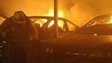 A Los Angeles city firefighter battles a garage fire set by an arsonist who set 12 new fires early Monday morning, in North Hollywood, California 