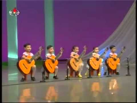 North Korean children playing the guitar. Creepy as hell.