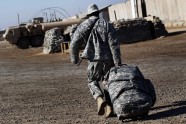 U.S. Army Sgt. Omar Sprott of the 115th Brigade Support Battalion carries his luggage in preparation for leaving Camp Kalsu near Hillla