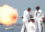 Gunners Mates 1st Class Ronnie Owens and Richard Ashley fire a 40MM saluting cannon in honor of the Florida Governor Jeb Bush.