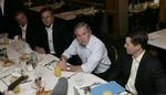 President George W. Bush meets business leaders and his brother, Florida Governor Jeb Bush, left, in Miami at the Versailles Restaurant and Bakery for a breakfast meeting Monday, July 31, 2006. )