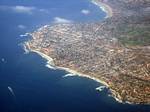 Panoramic view of La Jolla from above. La Jolla (play /ləˈhɔɪ.ə/ lə-hoy-ə) is an affluent,[2][3] hilly seaside resort community, occupying 7 miles (11 km) of curving coastline along the Pacific Ocean in Southern California within the northern city limits of San Diego.