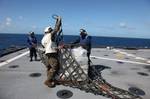 GULF OF MEXICO USS Oak Hill crewmembers prepare bales of cocaine, seized by a Coast Guard law enforcement team, for transport off of the USS Oak Hill, Dec. 9, 2011. Working jointly with the Oak Hills crew, the Coast Guard team, comprised of members from Pacific Tactical Law Enforcement Team, Tactical Law Enforcement Team South and Maritime Safety and Security Team San Diego (91109), interdicted more two tons of cocaine from the motor vessel Mr. Geo. U.S. Navy photo. (1486723) ( Coast Guard law e