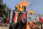 Members and activists of the Socialist Unity Center of India burn effigies of Egyptian President Hosni Mubarak, left, and President Barack Obama during a solidarity march in Calcutta, India, Monday, Feb. 7, 2011. Two weeks of political crisis that pushed the most populous Arab nation to the edge of anarchy appears to be settling into at least temporary stasis as the Egyptian government pledged Monday to investigate official corruption and election fraud.