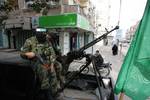 Palestinian Hamas militants patrol in the streets during the celebrations marking the Islamist movement's 24th founding anniversary, in the Rafah refugee camp in the southern Gaza Strip on December 19, 2011.Photo by Ahmed Deeb/wn