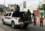 Palestinian Hamas militants patrol in the streets during the celebrations marking the Islamist movement's 24th founding anniversary, in the Rafah refugee camp in the southern Gaza Strip on December 19, 2011.Photo by Ahmed Deeb/wn