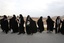 File - Head-to-toe veiled female Iranian students form a human chain around the Isfahan Uranium Conversion Facility in support of Iran's nuclear program, as one of them holds a poster of supreme leader Ayatollah Ali Khamenei, just outside the city of Isfahan, 410 kilometers, 255 miles south of the capital Tehran, Iran, Tuesday, Nov. 15, 2011.