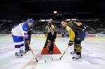 Capt. Susan K. Cerovsky, commanding officer of Center for Information Dominance drops, the ceremonial puck for the opening of a hockey game.