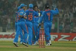 Indian cricketer Suresh Raina(L) with teammate Virat Kohli celebrate after taking the wicket of England cricketer Ravi Bopara during the final one day international (ODI) match between India and England at Eden Gardens Cricket Stadium in Kolkata on October 25, 2011. India lead the five match ODI series with an unassailable 4-0 lead.