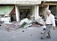 A Syrian man and boy, walk past destroyed shops at the scene where a car bomb blew up in a southern neighborhood near the junction to the city's international airport, in Damascus, Syria, Saturday, Sept. 27, 2008.