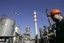 A worker is seen in the NIS Jugopetrol oil refinery, prior to a visit by Russian deputy prime minister Dmitry Medvedev, in Pancevo, some 16 kilometers (10 miles) north of Belgrade, Serbia, Monday, Feb. 25, 2008