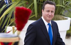 British Prime Minister David Cameron walks prior to a meeting at the G8 summit in Deauville, France, Friday, May 27, 2011.