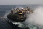 A landing craft air cushion (LCAC) assigned to Assault Craft Unit (ACU) 5 departs the well deck of the amphibious transport dock ship USS New Orleans (LPD 18).