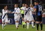 Inter's Wesley Sneijder, second left, of the Netherlands, is congratulated by his teammates Yuto Nagatomo, left, of Japan, and Dejan Stankovic, of Serbia, after he scored during a Serie A soccer match against Atalanta in Bergamo, Italy, Wednesday, Oct. 26, 2011.