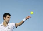 Novak Djokovic of Serbia serves to Janko Tipsarevic of Serbia during their round robin singles tennis match at the ATP World Tour Finals, at the O2 arena in London, Friday, Nov. 25, 2011.