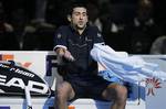 Serbia's Novak Djokovic reacts on the bench after losing a game to David Ferrer during a round robin single tennis match at the ATP World Tour Finals at O2 Arena in London, Wednesday, Nov. 23, 2011.