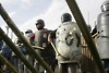 Slum residents stand ready to defend their neighborhood from police they expect to arrive with a court order to evict them in Sao Jose dos Campos