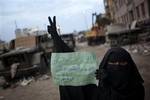 An Egyptian anti-Mubarak protester holds a banner reading in Arabic 