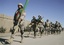 Afghan border policemen march to attend at the ceremony of transfer of authority from the NATO led International Security Assistance Force (ISAF) troops to Afghan security forces in Guzara, Herat province, west of Kabul, Afghanistan, Monday, Jan. 16, 2012.