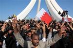 Demonstrators chant and wave Bahraini flags near the Pearl Monument on a main square in Manama, Bahrain, Tuesday Feb. 15, 2011. Thousands of protesters poured into the square in Bahrain's capital in an Egypt-style rebellion that sharply escalated pressure on authorities as the Arab push for change gripped the Gulf for the first time. Oppositions groups are calling for greater political freedom and an end to the ruling Sunni monarchy's grip on key decisions and government posts. The nation's majo