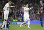 In this photo taken Wednesday Jan. 18, 2012, Real Madrid's Pepe from Portugal, left looks down at F.C. Barcelona's Lionel Messi from Argentina a moment before stamping on his hand as Jose Maria Callejon, centre protests to the referee after receiving a yellow card for his foul on Messi. Real Madrid's coach Jose Mourinho warned Real Madrid defender Pepe could face punishment for stamping on Messi's hand in Wednesday's 2-1 Copa del Rey loss to Barcelona. Pepe has a history of aggressive play in th