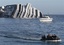 Italian navy scuba divers sail past the cruise ship Costa Concordia off the Tuscan island of Giglio, Italy, Saturday, Jan. 21, 2012.