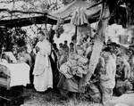 A US Navy chaplain celebrates Catholic Mass for Marines at Saipan, June 1944, commemorating comrades fallen in initial amphibious landings.