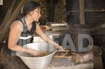 Maria Antonia Cordoba Leono, 29, prepares wood for a stove in San Lorenzo, El Salvador