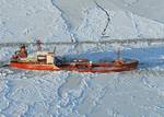 BERING SEA - The Russian-flagged tanker vessel Renda carries its important cargo 250 miles south of Nome, Alaska, as the Coast Guard Cutter Healy makes several passes around it to break the ice Jan. 6, 2012. The Healy crew is escorting the Renda to Nome to deliver 1.3 million gallons of fuel to the city. U.S. Coast Guard photo by Petty Officer 1st Class Sara Francis. (1489489) ( Healy escorts Renda )