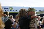 TAMPA, Fla. - A Clearwater, Fla., based Port Security Unit 307 member embraces his loved one after returning home from an extended deployment to the Middle East, Jan. 23, 2012. While deployed, PSU 307 members provided harbor defense and security to ports, seaward approaches, and waterways within U.S. Central Command's area of responsibility and ensuring the free flow of personnel, equipment and commerce in the region. U.S. Coast Guard photo by Petty Officer 3rd Class Tara Molle (1504194) ( PSU 3