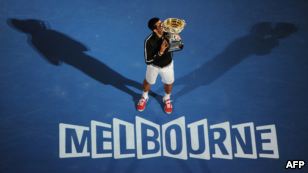 Novak Djokovic of Serbia kisses the trophy after his victory over Rafael Nadal of Spain in the men's final at the Australian Open tennis tournament in Melbourne.