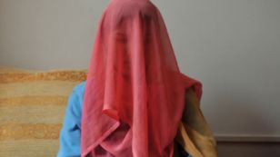 A veiled Kyrgyz bride sits for a photograph. Up to three-quarters of contemporary Kyrgyz brides are betrothed through "bride kidnapping" rituals. Now the Kyrgyz parliament is considering legislation that may chip away at the practice.