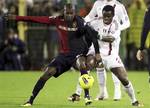 AC Milan Nigerian defender Taye Taiwo, right, and Cagliari's Víctor Ibarbo, of Colombia, challenge for the ball during an Italian Serie A soccer match between Cagliari and AC Milan at the Sant' Elia stadium in Cagliari, Italy, Tuesday, Dec. 20, 2011.