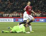 AC Milan forward Zlatan Ibrahimovic, top, of Sweden, reacts after scoring as Lazio's Federico Marchetti looks on during the Italian Cup quarter-final soccer match between AC Milan and Lazio, at the San Siro stadium in Milan, Italy, Thursday, Jan. 26, 2012.