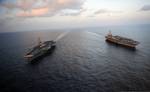 The Nimitz-class aircraft carriers USS Abraham Lincoln (CVN 72) and USS John C. Stennis (CVN 74) join for a turnover of responsibility in the Arabian Sea, 19 January, 2012.