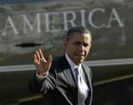 President Barack Obama waves as he walks off of Marine One on the South Lawn of the White House in Washington, Friday, Jan. 27, 2012.