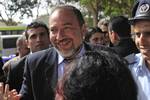 Surrounded by security, Yisrael Beiteinu leader Avigdor Lieberman visits the southern Israeli city of Ashkelon, Tuesday Feb. 10, 2009. The two front-runners in the race to rule Israel, Likud Party leader Benjamin Netanyahu and Foreign Minister and Kadima party candidate Tzipi Livni made last-minute appeals to voters as polls opened Tuesday in a close general election whose outcome could determine the course of Mideast peace negotiations.