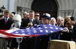 CLEARWATER, Fla. Petty Officer 3rd Class Amanda McKillip, a member of Coast Guard Air Station Clearwaters honor platoon, folders the national ensign during Lt. j.g. Frank Spatuzzis funeral ceremony at St. Cecelia's Catholic Church in Clearwater Fla., Jan. 21, 2012. Spatuzzi died Jan. 13, at Suncoast Hospice House in Brookside, Fla., after his health declined from a fall he suffered Dec. 24, 2011. He was 93. U.S. Coast Guard photo by Petty Officer 3rd Class Michael De Nyse. (1503224) ( )