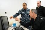 A Sailor demonstrates to Chief of Naval Personnel Vice Adm. Scott R. Van Buskirk how the experimental computer-based teaching program, Digital Tutor works.