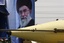 Iran's Shahab-3 ballistic missile is paraded by Iranian Revolutionary Guard in front of a picture of supreme leader Ayatollah Ali Khamenei, during a military parade ceremony marking the 29th anniversary of the start of the 1980-1988 Iraq-Iran war, in front the mausoleum of late revolutionary founder Ayatollah Khomeini, just outside Tehran, Iran, Tuesday, Sept. 22, 2009.