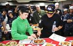 Cmdr. Kristen Fabry, left, and Master Baker Chef Leslie Bilderback judges dishes during an baking competition in the bake shop