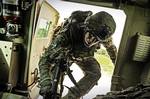 Spc. Michael Bartolo, rifleman attached to Laghman Provincial Reconstruction Team, climbs back in his vehicle after a sweep for roadside bomb triggermen in Alingar District, Laghman Province, Aug. 8. The PRT is serving as the Quick Reaction Force, ready to respond at a moment's notice to unexpected incidents in the province. The QRF was called up to escort the explosives ordinance disposal team to a found IED site while clearing previous blast sites along the way. (U.S. Air Force photo/ Staff Sg