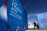 A man walks in front of the Deauville Congress Center, in Deauville, western France on Monday, May 23, 2011 where world leaders of the G8 will meet for a summit May 26 and May 27.