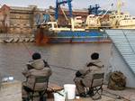 Men fish alongside the Tirdzniecības Kanāls (Trade Canal)