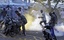 Supporters of Mohamed Nasheed, who resigned Tuesday from his post as Maldivian President, take cover from tear gas canisters during a protest in Male, Maldives, Wednesday, Feb. 8, 2012.