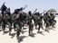 File - Hundreds of newly trained Shabaab fighters perform military exercises in the Lafofe area some 18Km south of Mogadishu on Thursday Feb. 17, 2011.