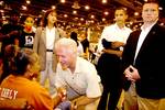 Clinton greets a wheel chair bound Hurricane Katrina evacuee in the Reliant Center at the Houston Astrodome on September 5, 2005. In the background holding his jacket is then-Senator Barack Obama.