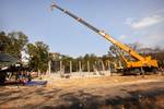 A crane operated by a Royal Thai soldier lowers a metal truss onto a multipurpose building being constructed at the Ban Lumngoen school in Pak Tong Chai, Nakhon Ratchasima province, Thailand, Jan. 26, 2012, during exercise Cobra Gold 2012. The building was constructed by Royal Thai Armed Forces and Malaysian service members, along with U.S. Soldiers with the 643rd Engineer Company. Cobra Gold is a regularly scheduled joint/combined exercise designed to ensure regional peace and strengthen the ab